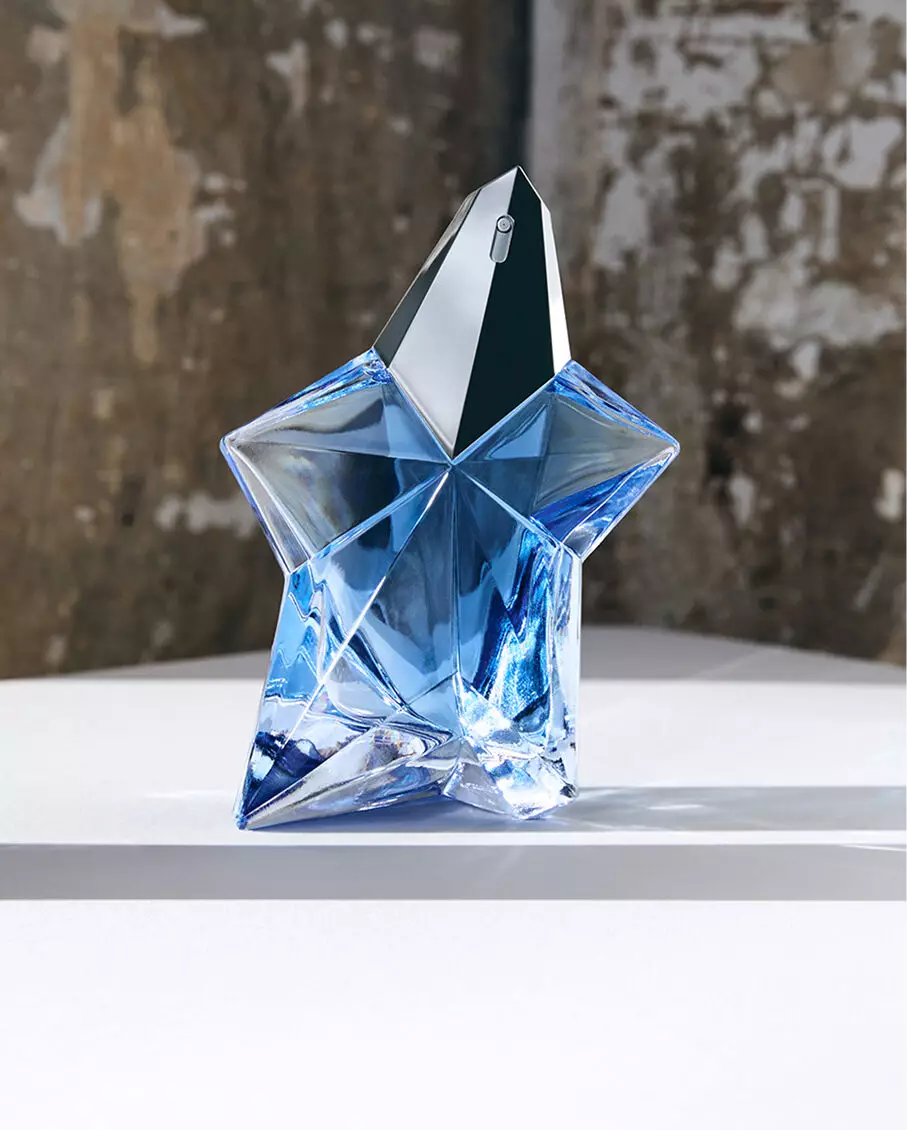 Mugler Angel Eau de Parfum blue star bottle resting on a studio surface.